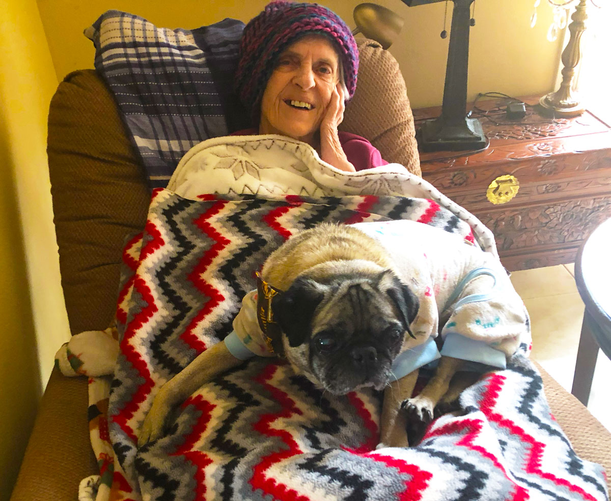 Resident relaxing at Angel's Guest Home with a dog